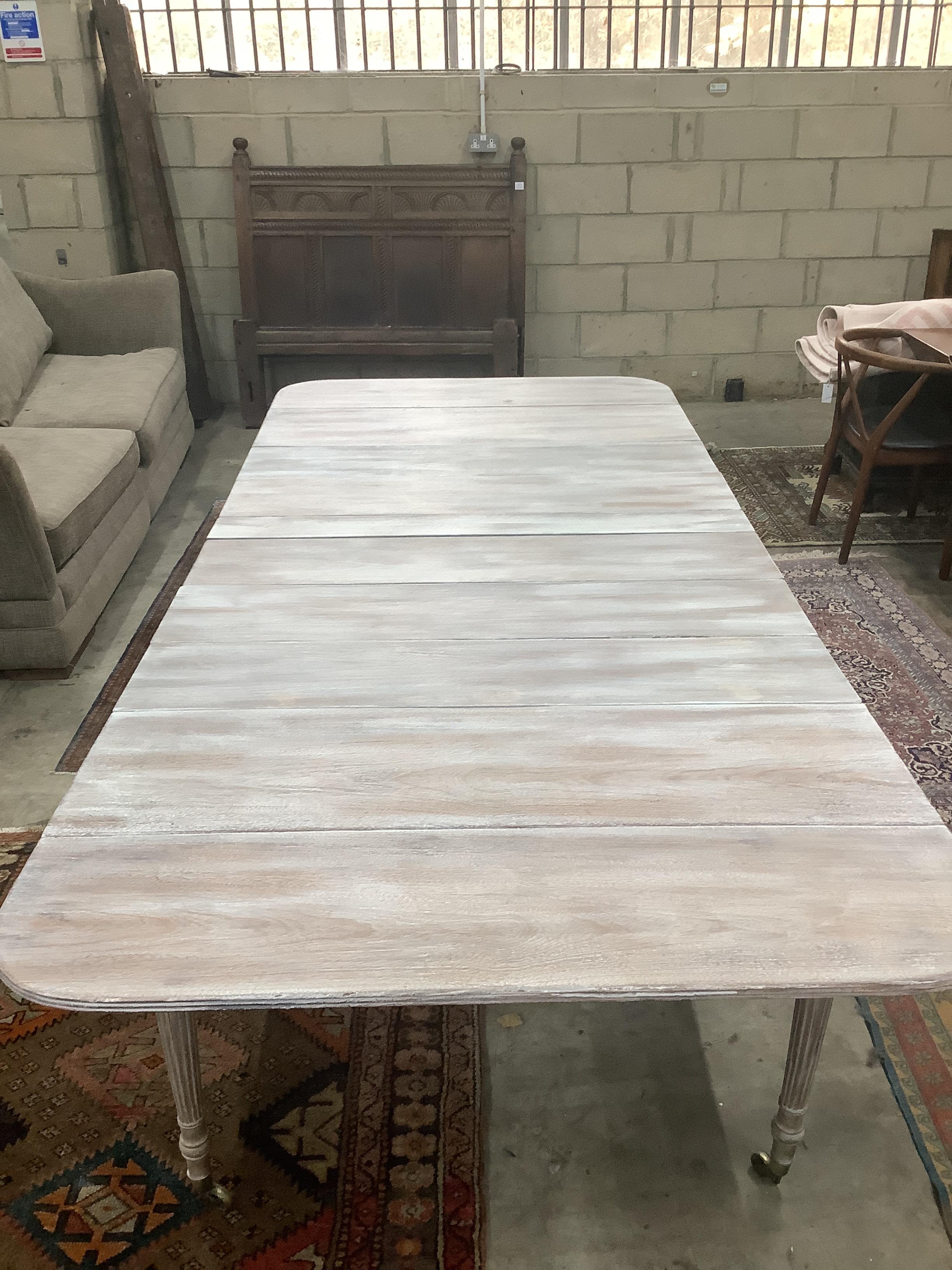 A George III stripped mahogany extending Pembroke dining table with six leaves, 261cm extended, width 120cm, height 73cm